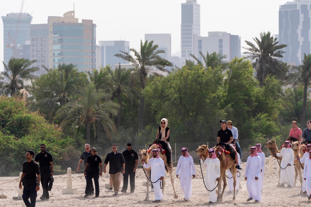 Homeland Security Secretary Kristi Noem and Corey Lewandowski ride camels to a tour of Qal'at al-Bahrain Fort, on May 25, 2025 in Bahrain (Getty Images)