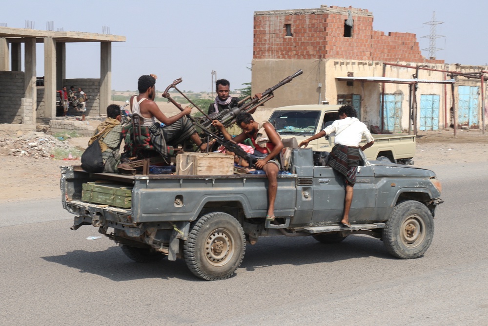 Forces loyal Yemen's Saudi-backed government ride in a pick-up truck in the Hays district, south of Hodeidah on September 5 (AFP/Getty)