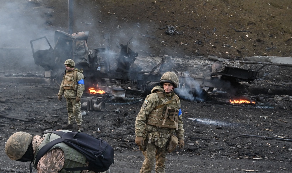 Ukrainian service members look for and collect unexploded shells after a fighting with Russian raiding group in the Ukrainian capital of Kyiv (AFP/Getty)