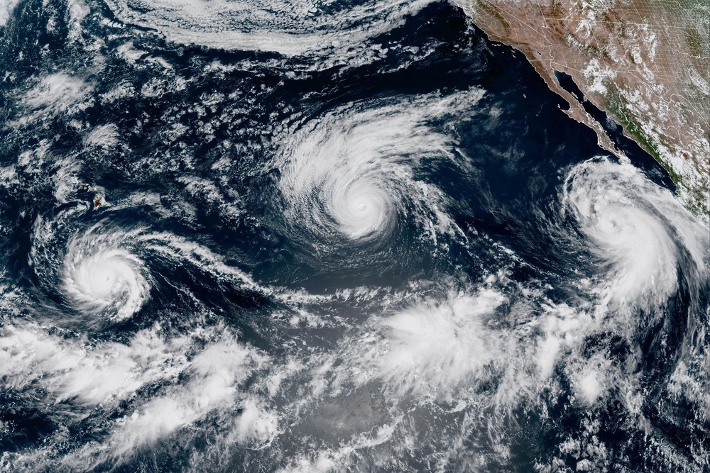 This satellite image provided by CIRA/NOAA shows three storms, from left, Hurricane Lowell, Hurricane Karina and Tropical Storm Marie in the Pacific Ocean. (CIRA/NOAA)