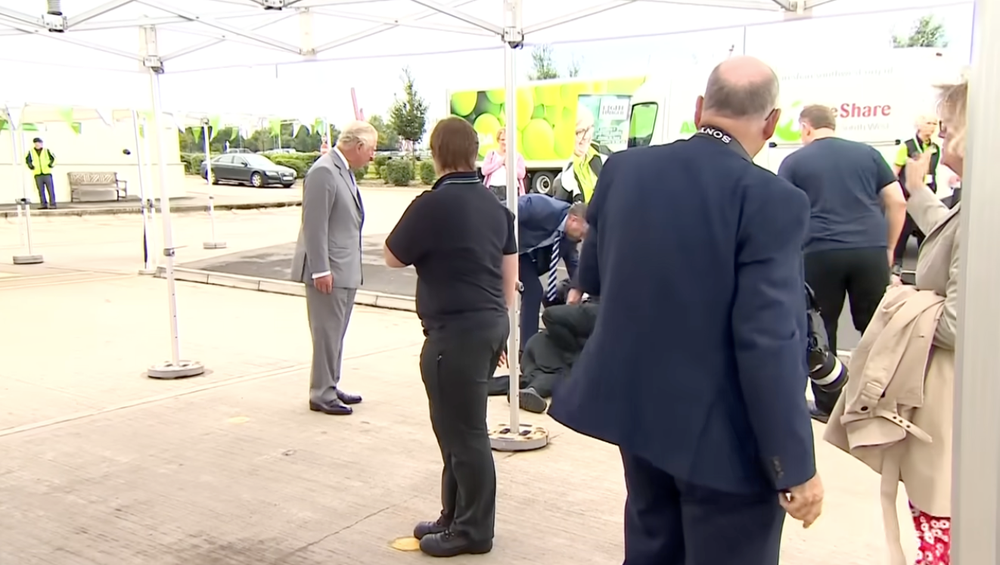 The full footage showed King Charles putting out his arm to try and catch the supermarket worker who remained close by as the man received medical attention. The king only moved away after his security detail reassured him the individual was OK (PA)