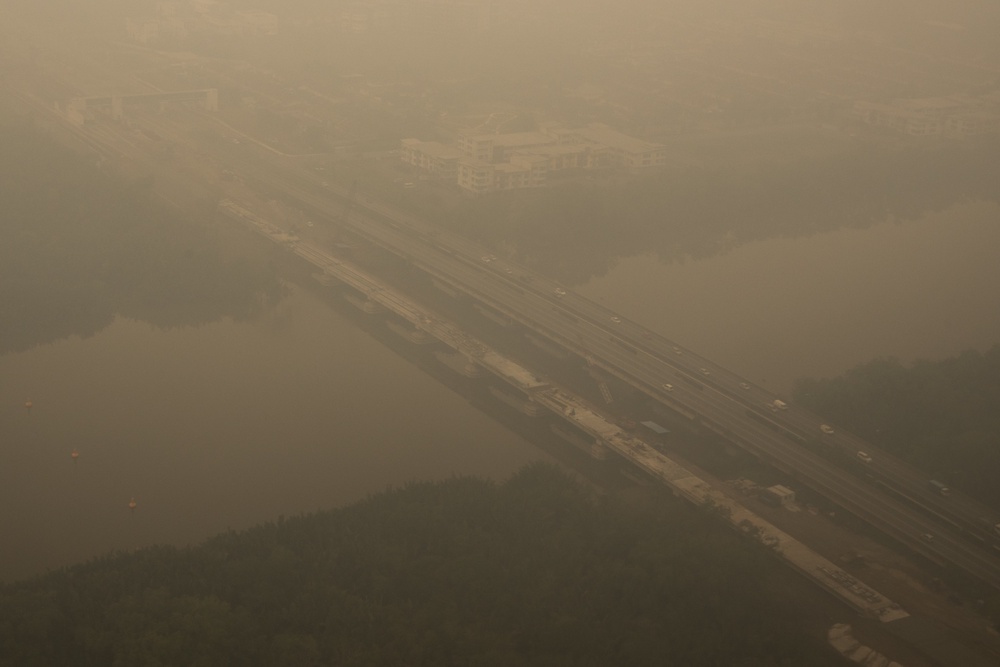 This aerial photo taken from a commercial aircraft shows haze from Indonesian forest fires blanketing a bridge in Kuching, the capital city of Malaysia's Sarawak state on the island of Borneo on September 5, 2026 (AFP/Getty)