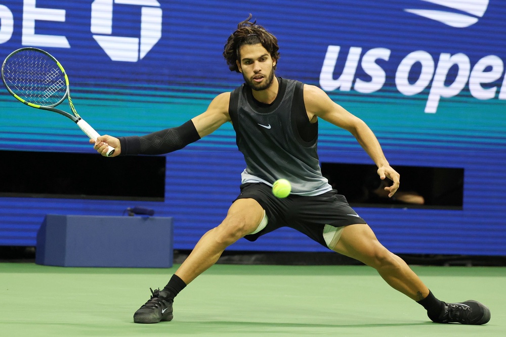 Carlos Alcaraz, of Spain, hits a return against Ben Shelton, of the United States (AP)