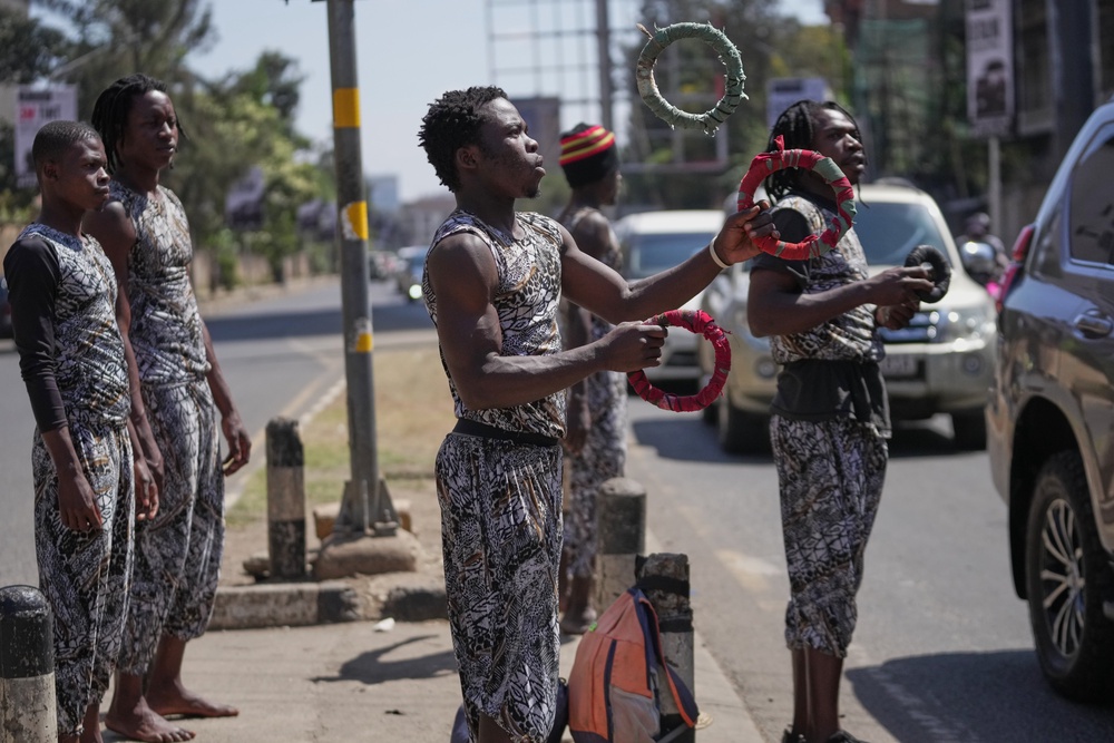 A man juggles on a busy roadside in Nairobi (AP Photo/Brian Inganga)
