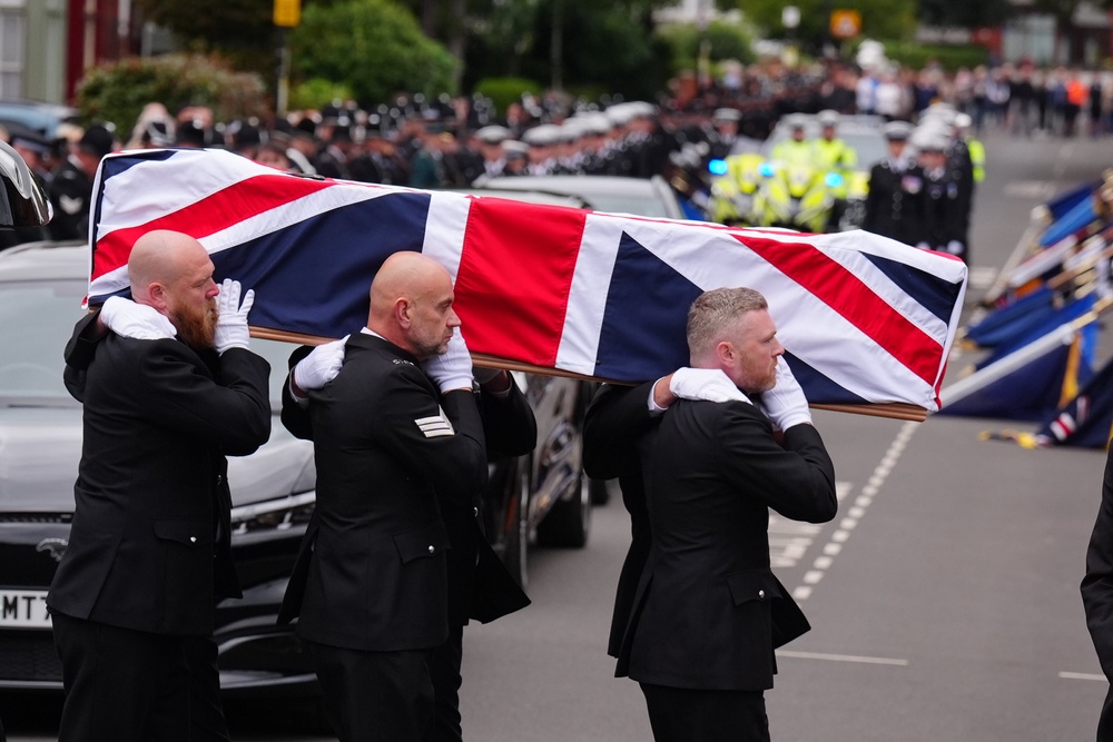 Pall bearers carry the coffin of PC Matthew Blades. (PA)