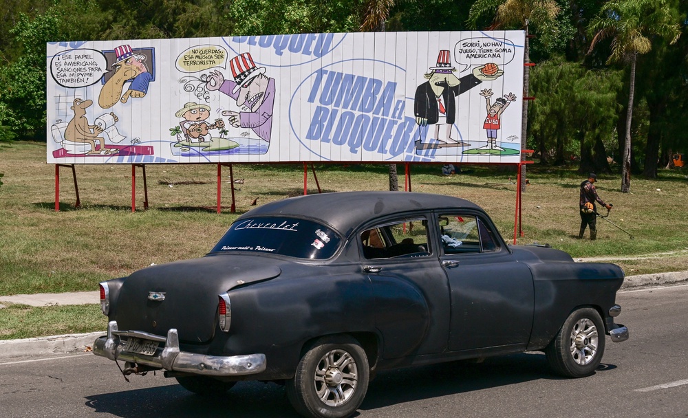 An old car drives past a billboard against the US blockade in Havana on August 25, 2026 (AFP via Getty Images)