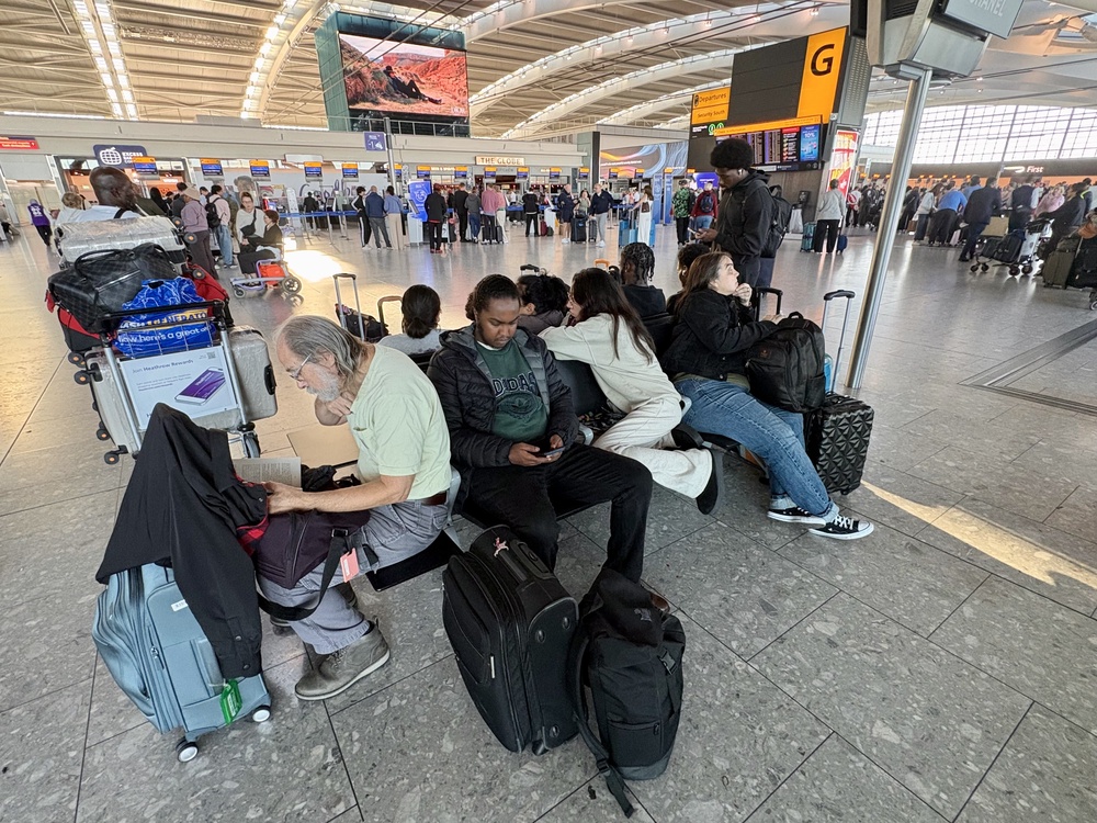 Passengers at Heathrow Airport (PA) (PA Wire)