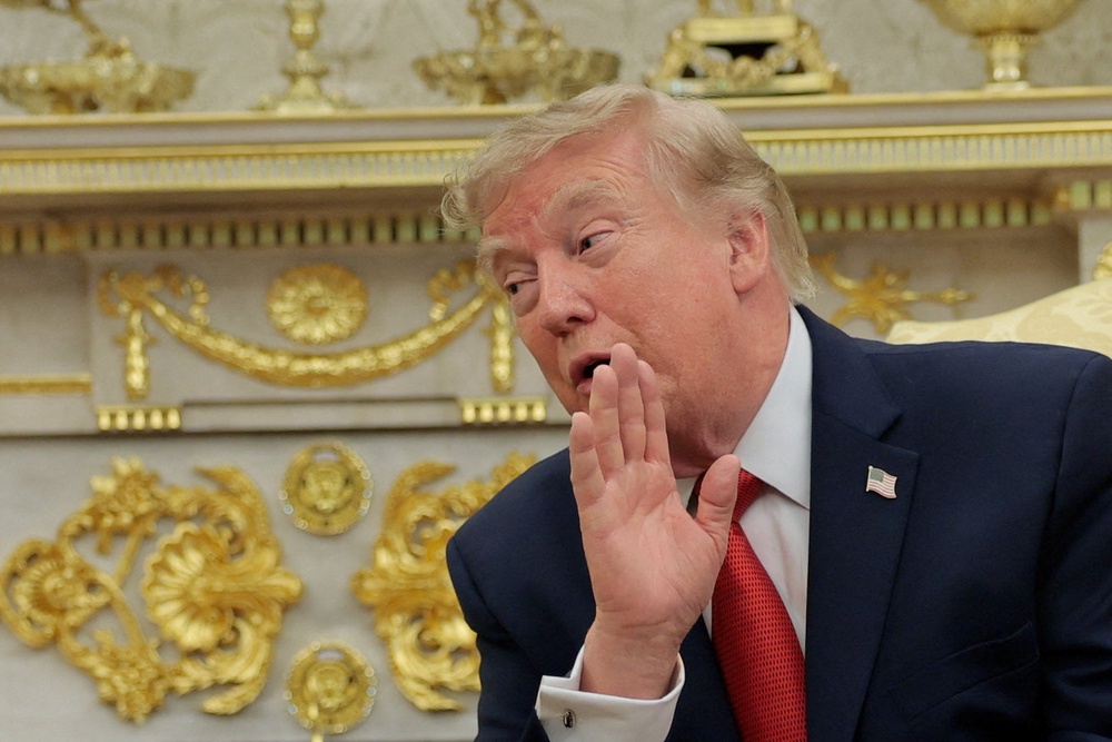 Trump is seen in front of some of the many gold-leaf accents he’s added to the Oval Office (Reuters)