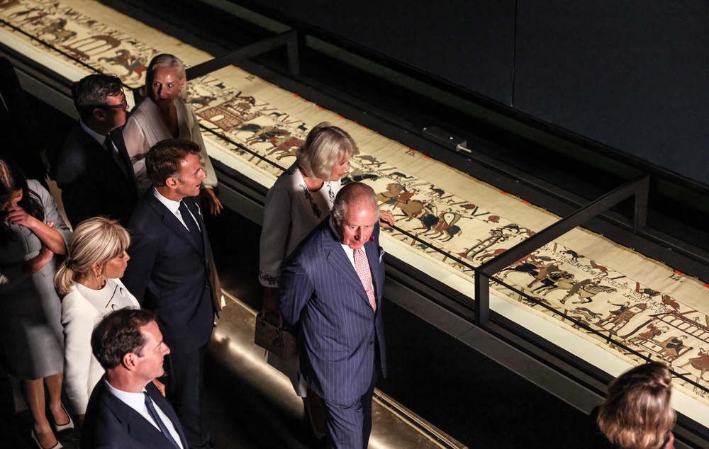 The King and Queen viewed the tapestry with France’s President Emmanuel Macron and PM Andy Burnham (Richard Pohle/The Times/PA) (PA Wire)