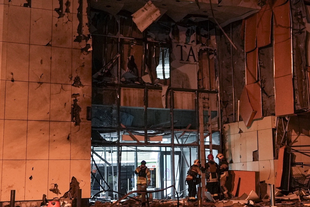 Rescuers work at the site of a shopping mall hit by an evening Russian drone strike in Sumy (Reuters)