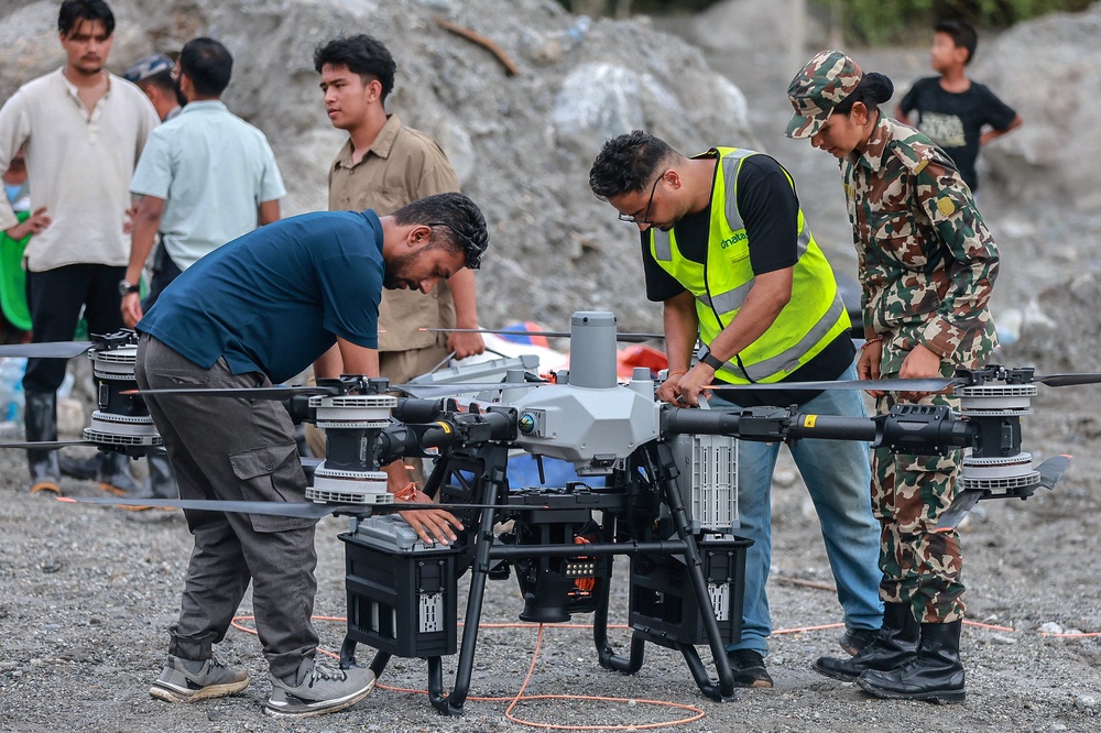 Technicians prepare a drone before it carries relief supplies to a flood-affected area in Trishuli in Nepal on 4 September 2026 (AFP/Getty)