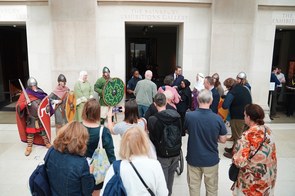 People dressed as reenactors welcome members of the public to the British Museum (PA)