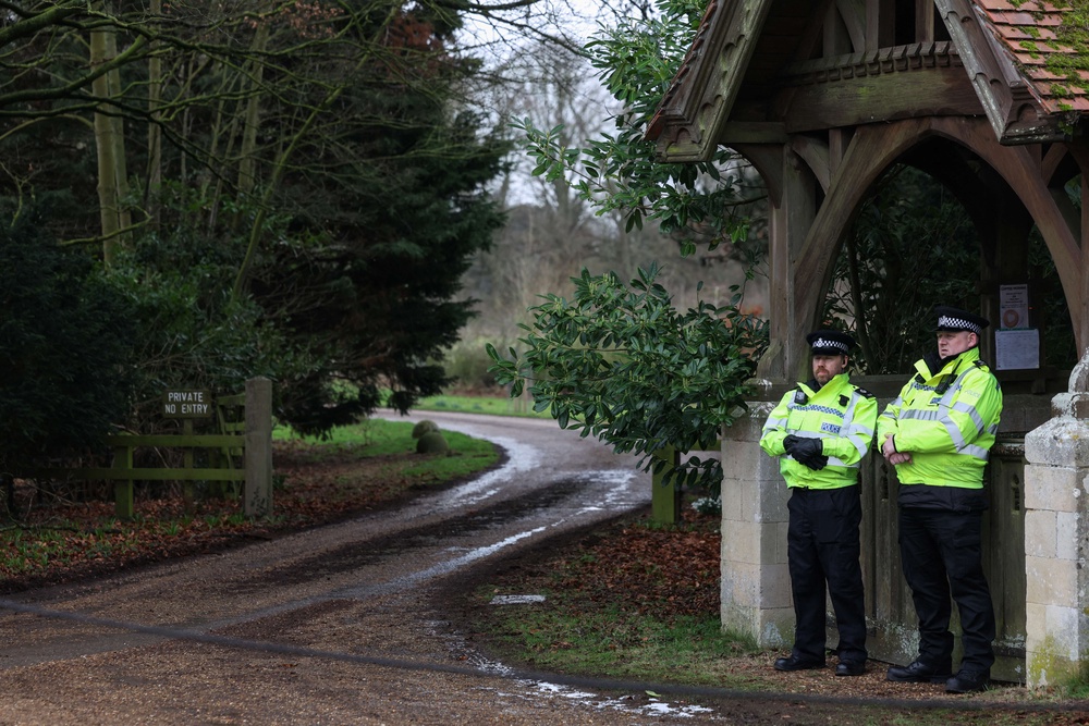 Police stand guard at an entrance to Wood Farm on the royal family's Sandringham Estate in Norfolk, eastern England on February 21, 2026, after Britain's former prince Andrew was arrested on February 19 (AFP/Getty)