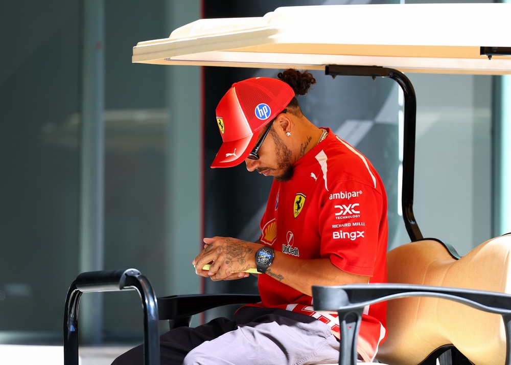 Lewis Hamilton of Great Britain and Scuderia Ferrari looks at his phone in Madrid, Spain (Getty)