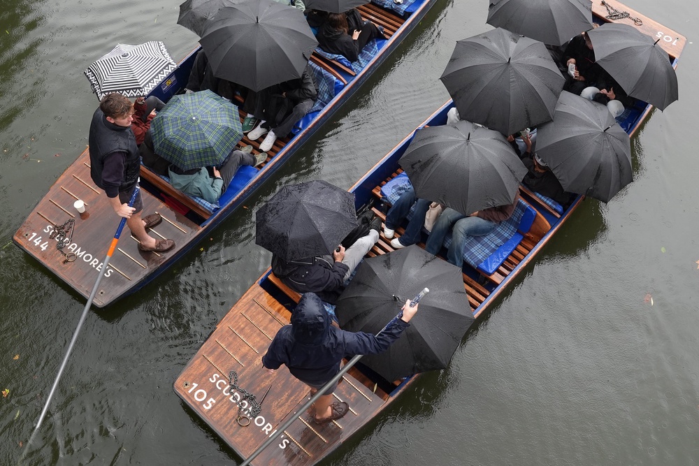People brave the rain for a wet weather punt tour along the River Cam in Cambridge (Joe Giddens/PA) (PA Wire)