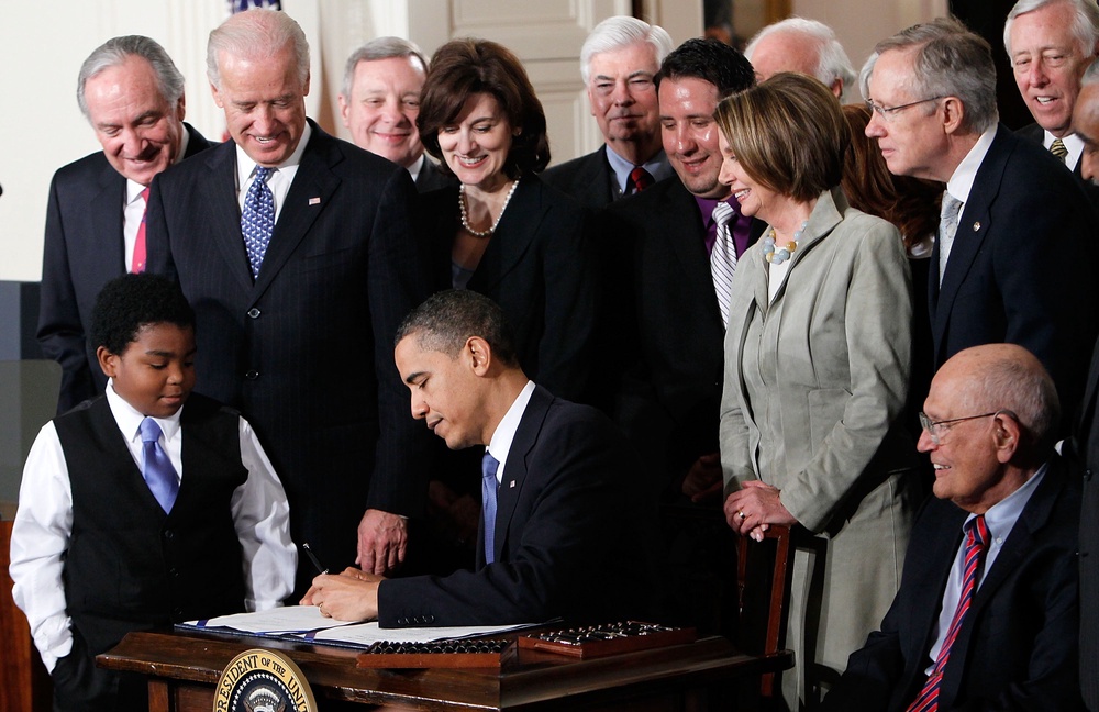 Barack Obama signs the Affordable Health Care for America Act during a ceremony with fellow Democrats in the East Room of the White House March 23, 2010 in Washington, DC (Getty Images)
