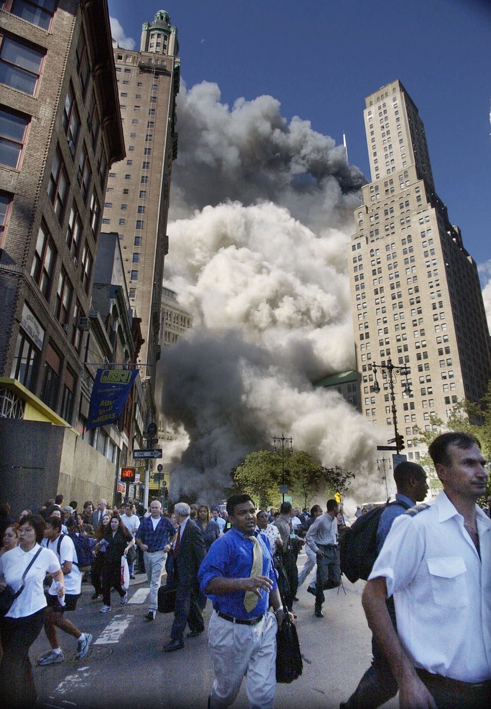 Pedestrians flee the World Trade Center area as the center's south tower collapses following a terrorist attack on the New York landmark, Sept. 11, 2001 (AP Photo/Amy Sancetta)