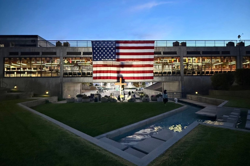 Turning Point shared a photo on social media Thursday of the site where Kirk was killed, resembling a shrine with an American flag and a wooden cross. The Independent understands that neither the cross nor the flag are permanent fixtures on campus (Turning Point USA)