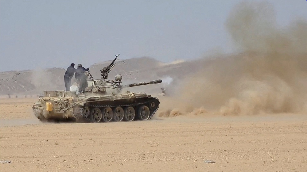 Members of the Saudi-backed Yemeni government forces fire a tank during what they say to be clashes with Yemen's Iran-aligned Houthis in a location given as near Al-Hazm, Yemen, in this screen grab obtained from a handout video released September 9 (Reuters)