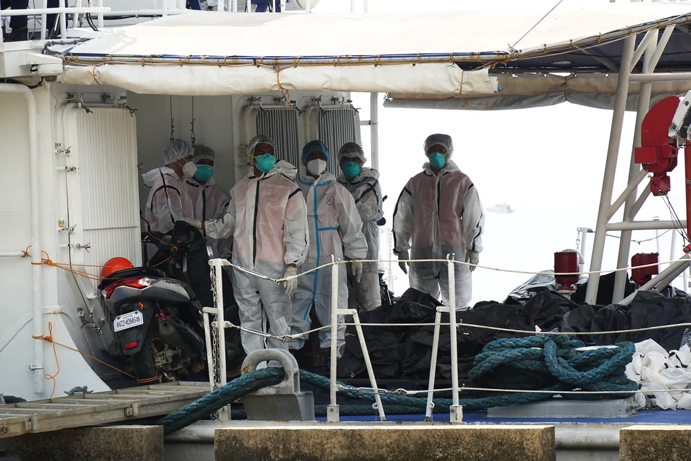 Philippine coast guard personnel stand next to body bags of victims of the ferry fire in Coron, Palawan province, on 12 September 2026 (AFP/Getty)