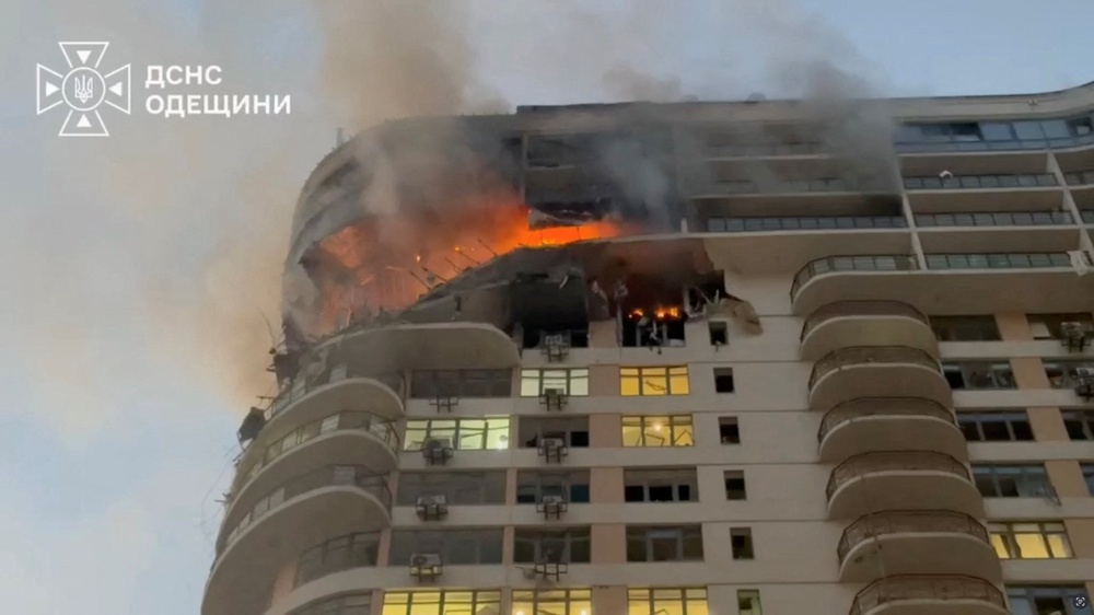 Flames and smoke rise from a residential building in the aftermath of a strike, in Odesa (Reuters)