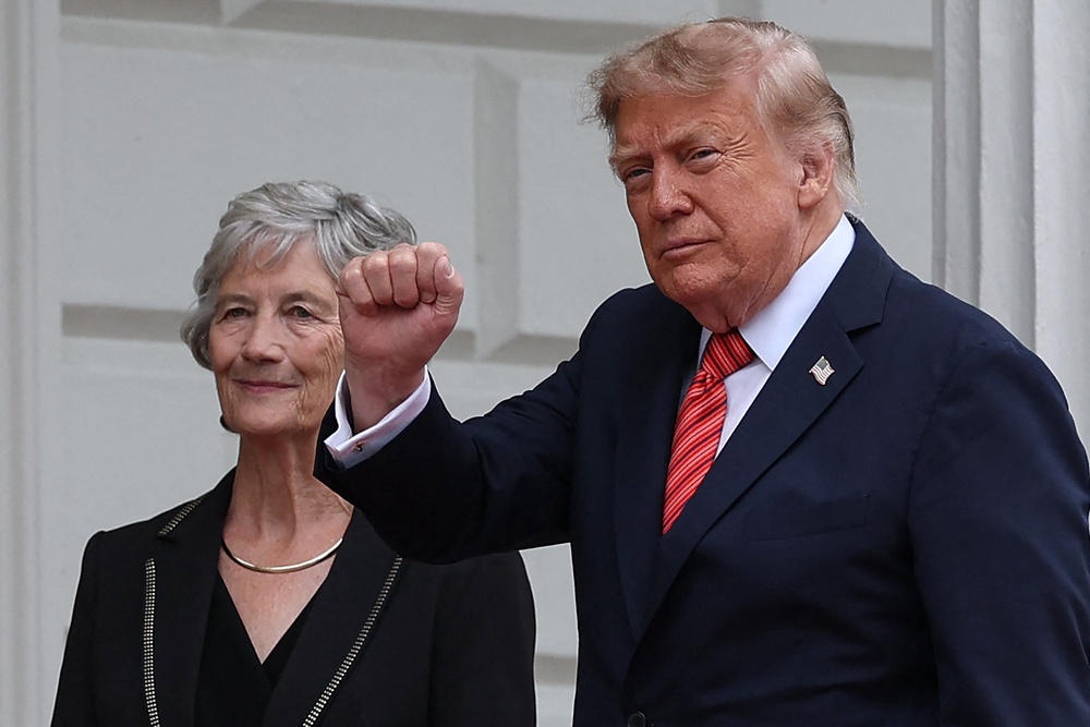 Mr Trump gestures as he is welcomed by Ireland's president Catherine Connolly at Áras an Uachtaráin in Phoenix Park in the Irish capital Dublin (AFP/Getty)