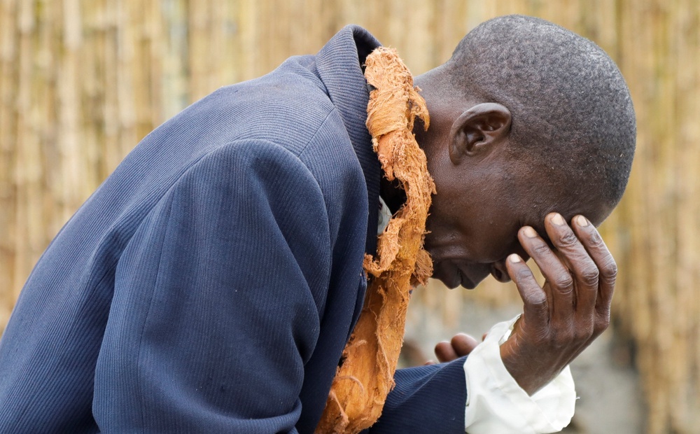 A mourner reacts near the entrance of the Karuziika Royal Palace, where the body of the late Omukama of Tooro, King Oyo Nyimba Kabamba Iguru Rukidi IV, lies in state during a nine-day official mourning period ahead of burial at the Karambi Royal Tombs, in Fort Portal, Kabarole District, Uganda, September 11, 2026 (Reuters)