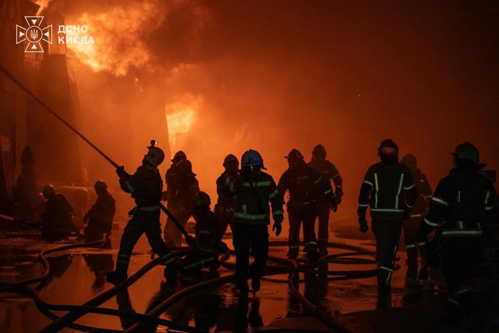 Firefighters put out a fire following a Russian drone attack in Kyiv on Friday (Ukrainian Emergency Service via AP)