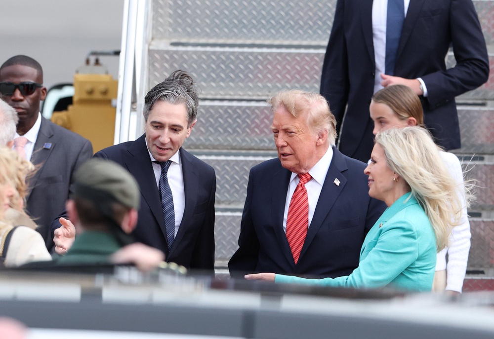 US President Donald Trump is greeted by Tanaiste Simon Harris as he arrives on Air Force One at Dublin Airport (Clodagh Kilcoyne/PA) (PA Wire)