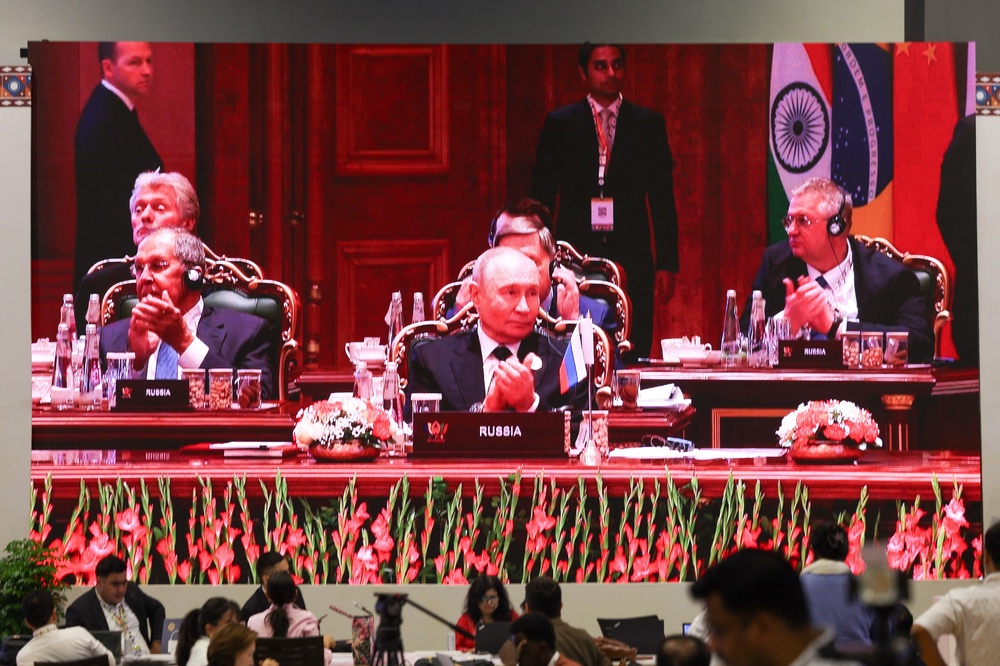 A screen shows Russian president Vladimir Putin during the Brics Summit in Delhi (Reuters)