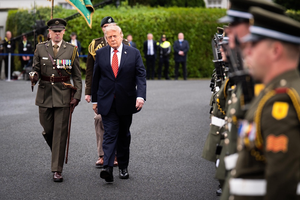 US President Donald Trump views the guard of honour outside Áras an Uachtaráin (James Manning/PA) (PA Wire)