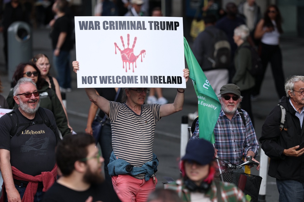 People take part in an anti-Trump protest march through Dublin city centre (Clodagh Kilcoyne/PA) (PA Wire)