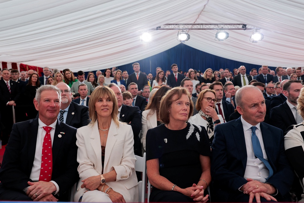 Ireland's prime minister (Taoiseach) Micheal Martin, his wife Mary O’Shea, US ambassador to Ireland Edward Walsh and his wife Lynn Walsh listen to Mr Trump (Reuters)
