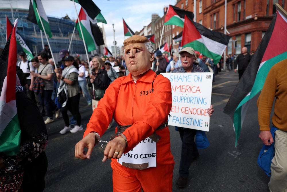 People take part in a protest against the visit of Mr Trump in Dublin (AFP/Getty)