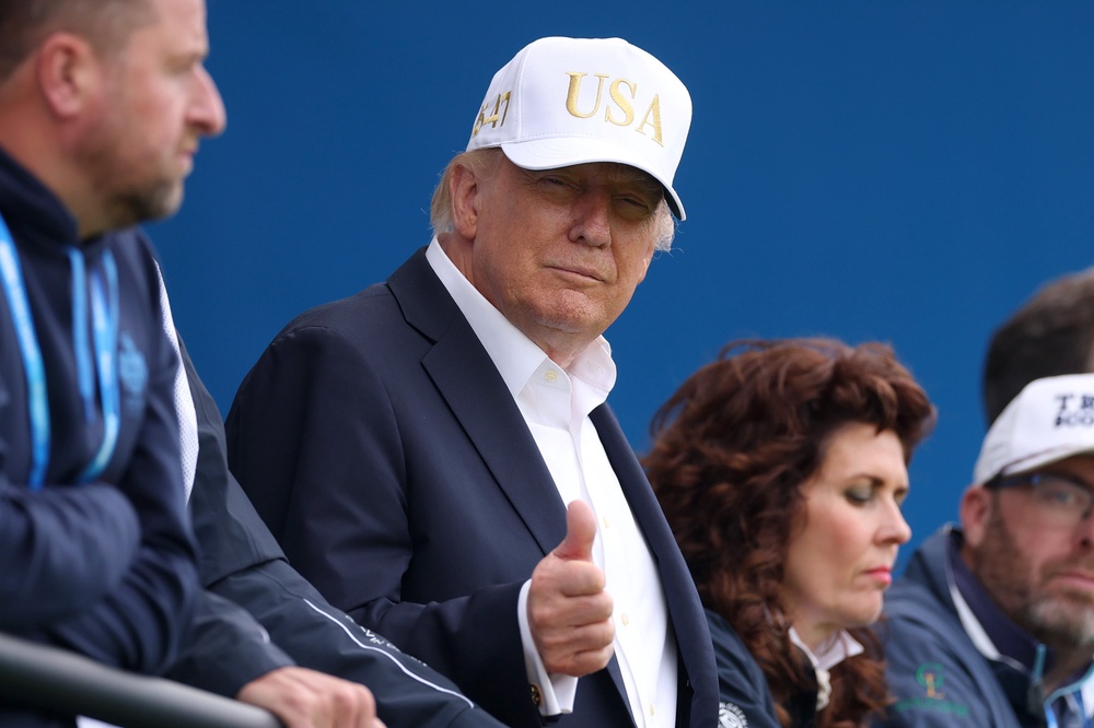 Trump gestures a thumbs up as he looks across the 18th green on day three of the Amgen Irish Open at Trump International Golf Links in Doonbeg (Getty)