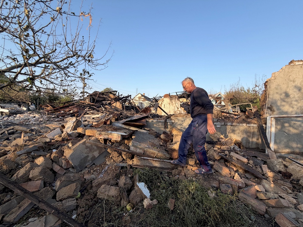 A local resident walks through the rubble of a neighbouring destroyed house, where two people were killed following an air strike in Zaporizhzhia early on 12 September 2026 (AFP/Getty)