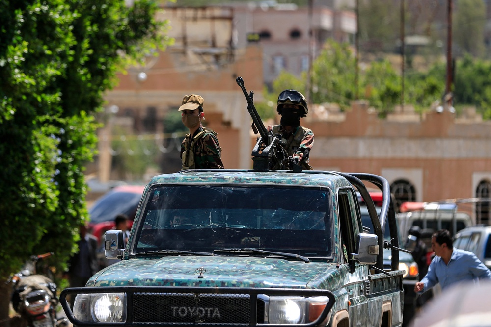 Yemen's Houthi armed forces patrol as Yemeni prisoners loyal to the Houthi authorities arrive in the capital Sanaa on 12 September 2026 (AFP/Getty)
