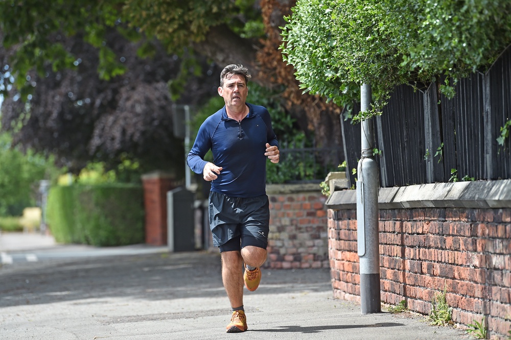 Andy Burnham running near his house (Peter Powell/PA) (PA Wire)