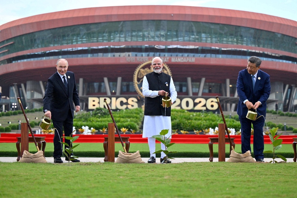 Russia's Vladimir Putin, India's Narendra Modi and China's Xi Jinping take part in a plantation event during the Brics summit in Delhi on 12 September 2026 (Reuters)