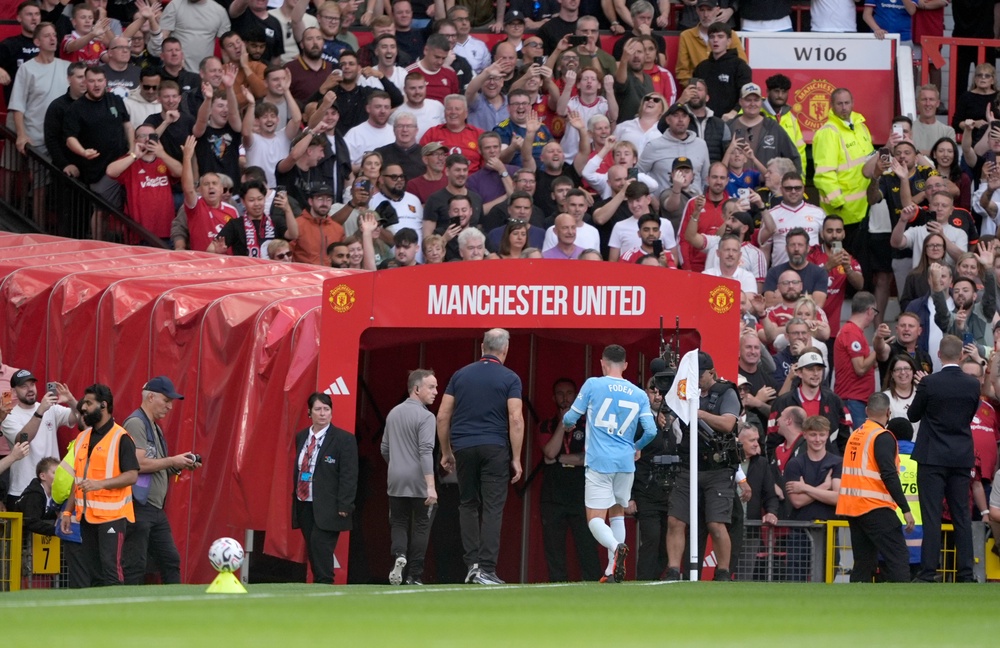 Foden runs down the tunnel after being shown a red card (PA)
