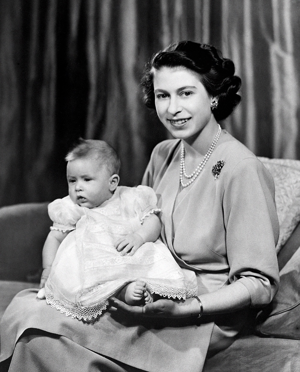 Princess Elizabeth with her baby son Prince Charles in a private room at Buckingham Palace in April 1949 (PA) (PA Archive)
