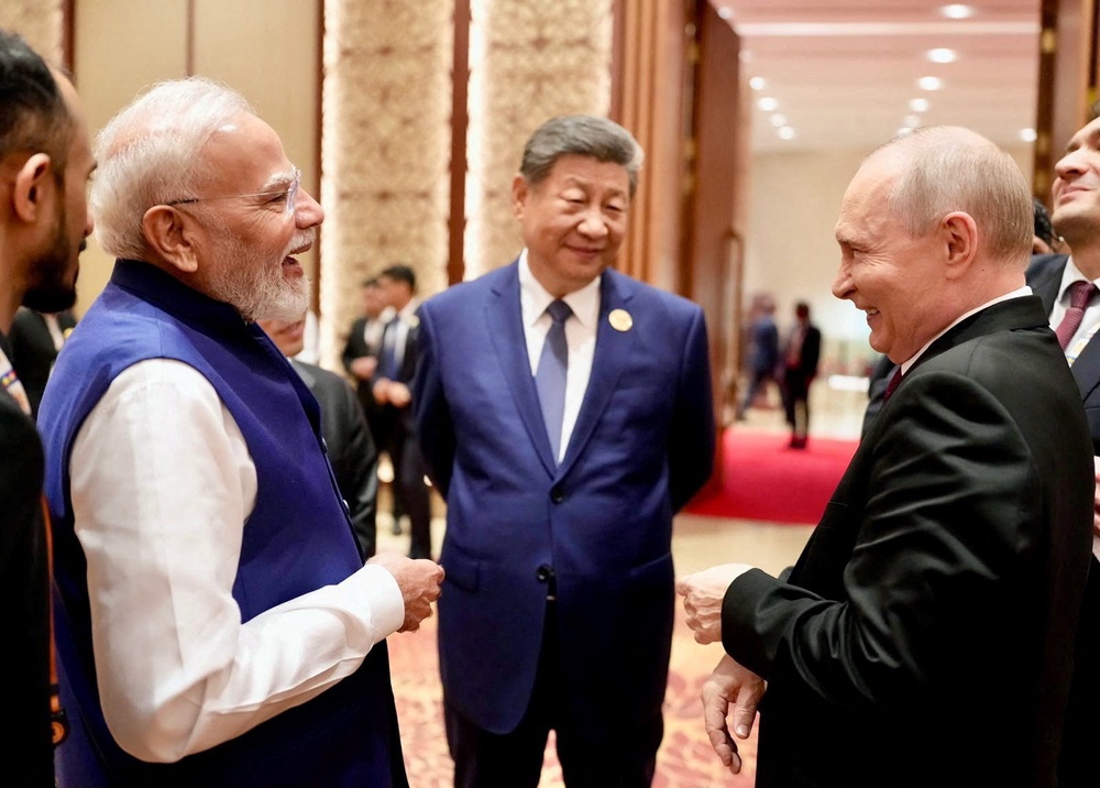 Indian prime minister Narendra Modi with Chinese leader Xi Jinping and Russian president Vladimir Putin at the Brics summit in Delhi (Reuters)