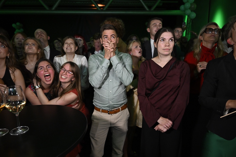 Green Party members react to the presentation of the exit poll at the election night watch party, in Stockholm (AP)