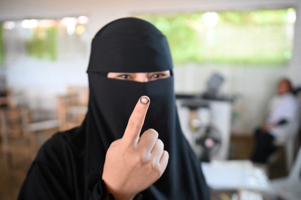 A woman shows the electoral ink on her finger after voting in Saguiaran on the southern island of Mindanao (AFP/Getty)