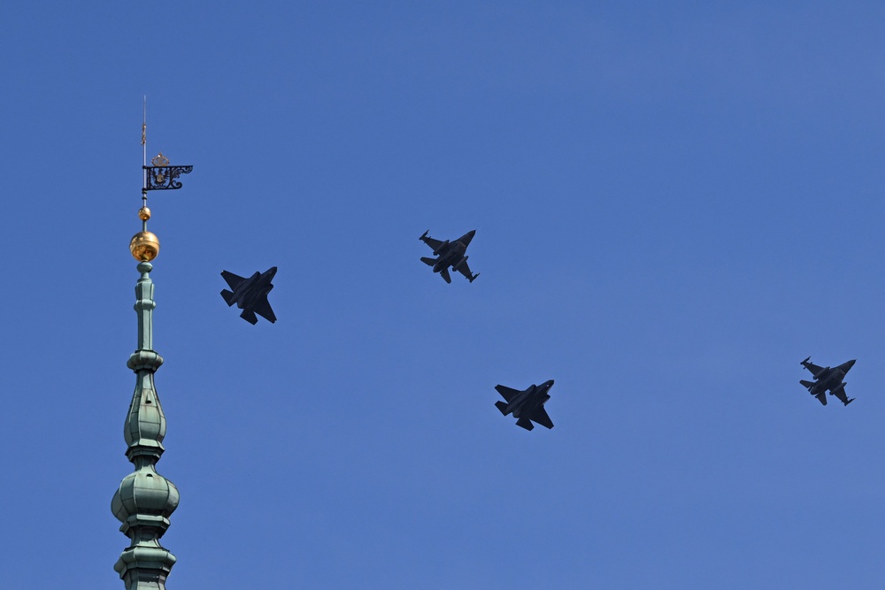 Two US-made F-35 (L and 2nd R) and two F-16 fighter jets fly past the top of the clock tower (L) of the Royal Castle in Warsaw on June 12, 2026, during a ceremonial flyover across Poland welcoming the first F-35 aircraft into service with the Polish Air Force. (AFP/Getty)