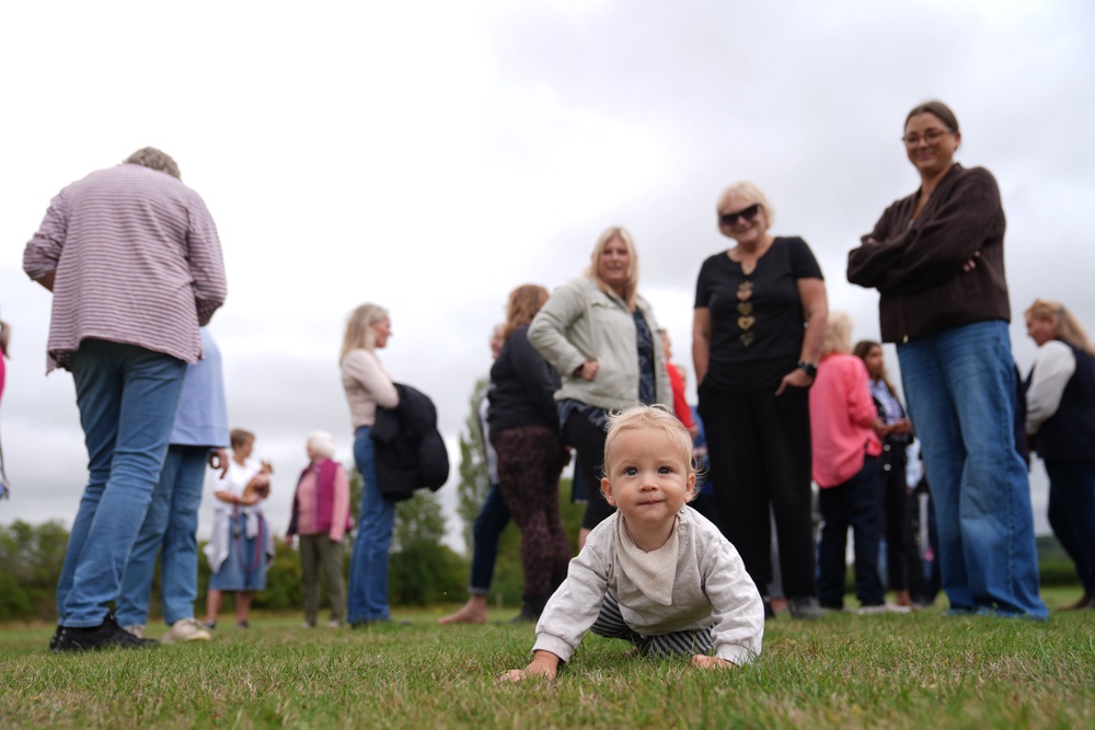 Zach, 10 months, and female residents of Piddington village in Oxfordshire gathered by ex-military base MoD Bicester (Joe Giddens/PA) (PA Wire)