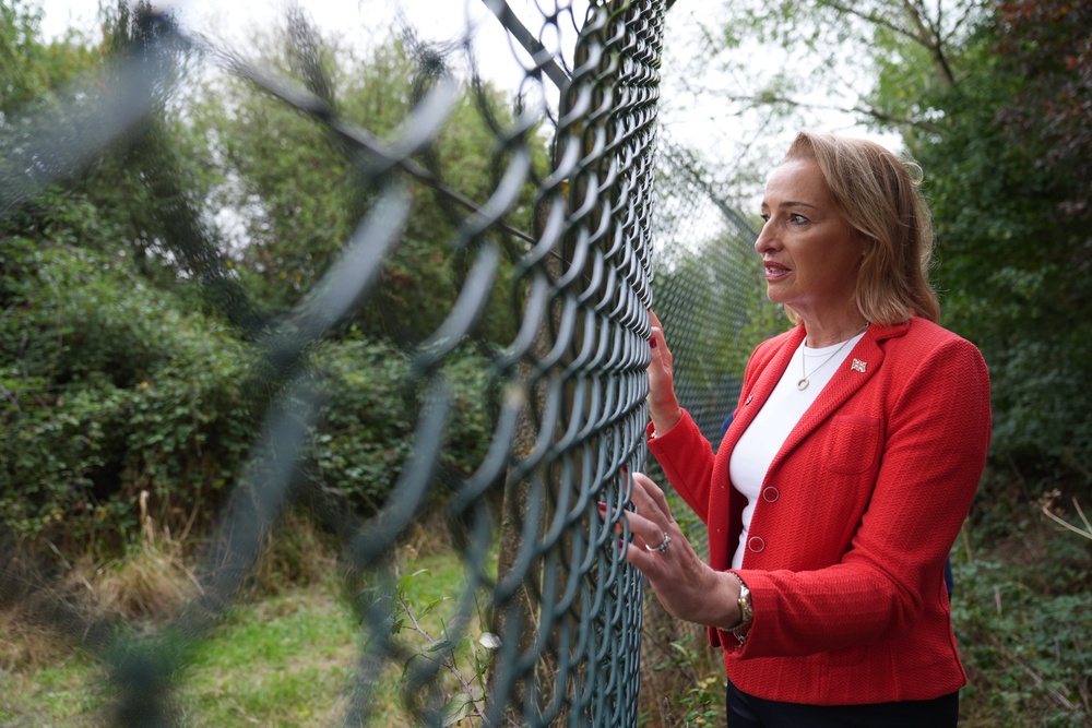 Reform UK MP Sarah Pochin looks through the wire fence of MoD Bicester (Joe Giddens/PA) (PA Wire)