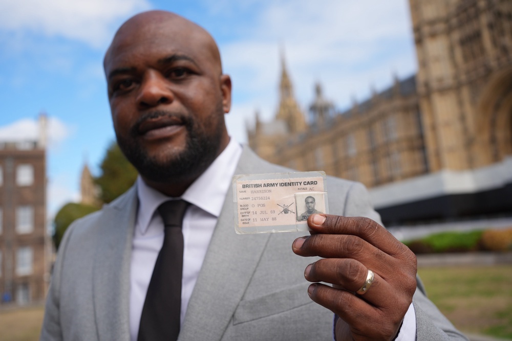 Andy Seaman, whose brother Pte Tony Harrison was killed in Belfast in 1991, displays his brother’s military ID card on College Green ahead of a parliamentary briefing (Yui Mok/PA) (PA Wire)