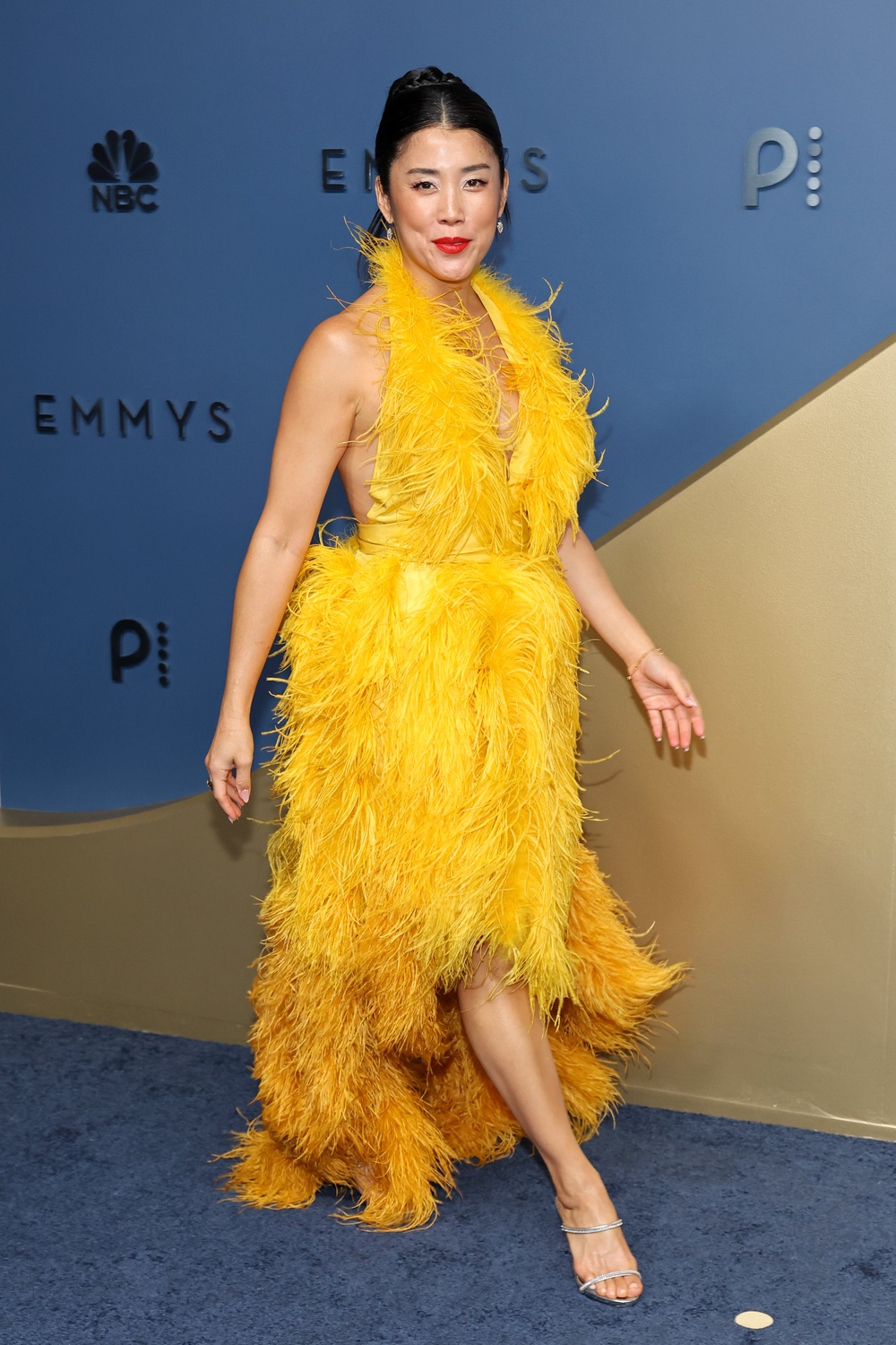 'Your Friends and Neighbors' star Eunice Bae arrived in a yellow feathered frock. It’s giving Big Bird from ‘Sesame Street’ — not 78th annual Emmy Awards (Getty)