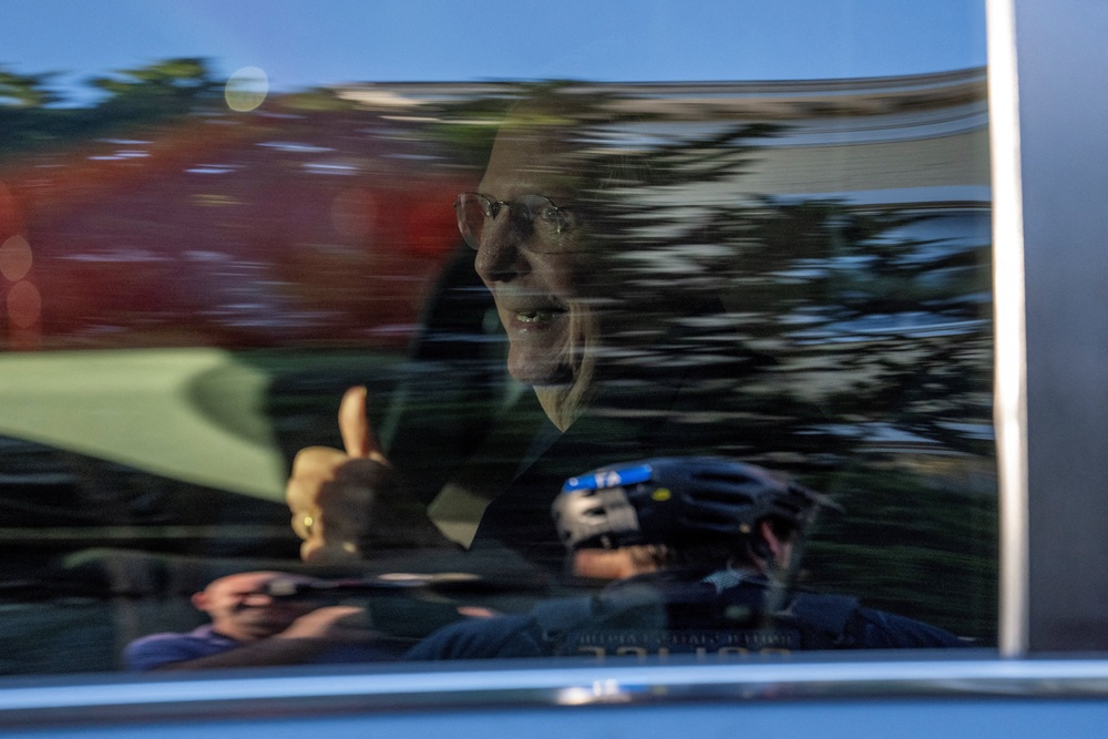 McConnell smiles and gives a thumbs-up to reporters and spectators outside of his D.C. townhome (Reuters)